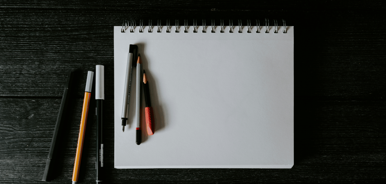 pen and pencil on note pad